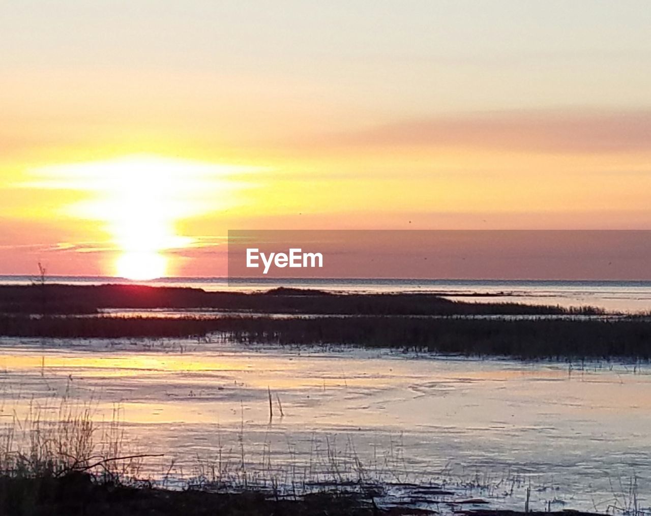 SCENIC VIEW OF SEA AGAINST ORANGE SKY