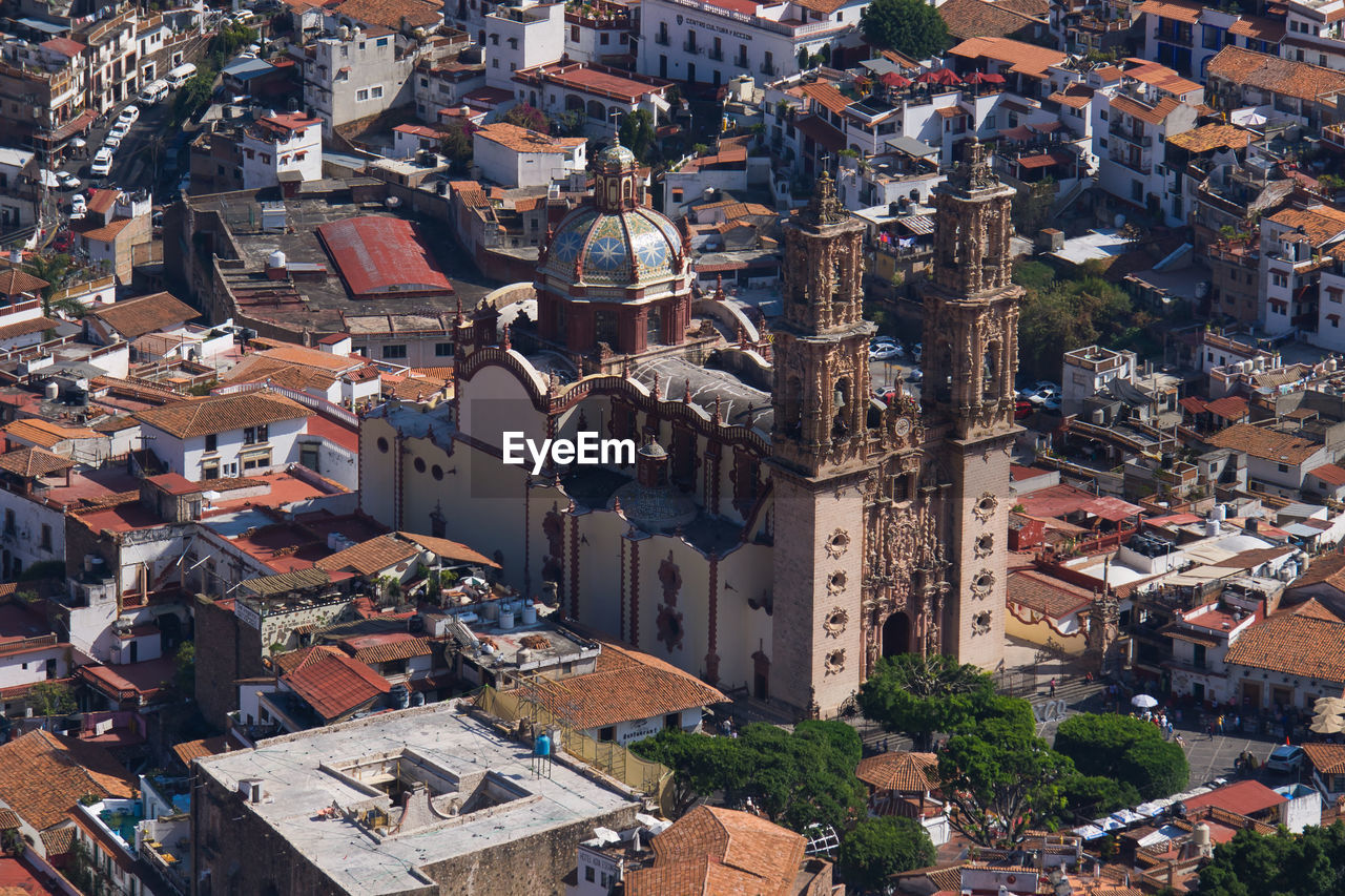 High angle view of buildings in city and santa prisca cathedral on taxco