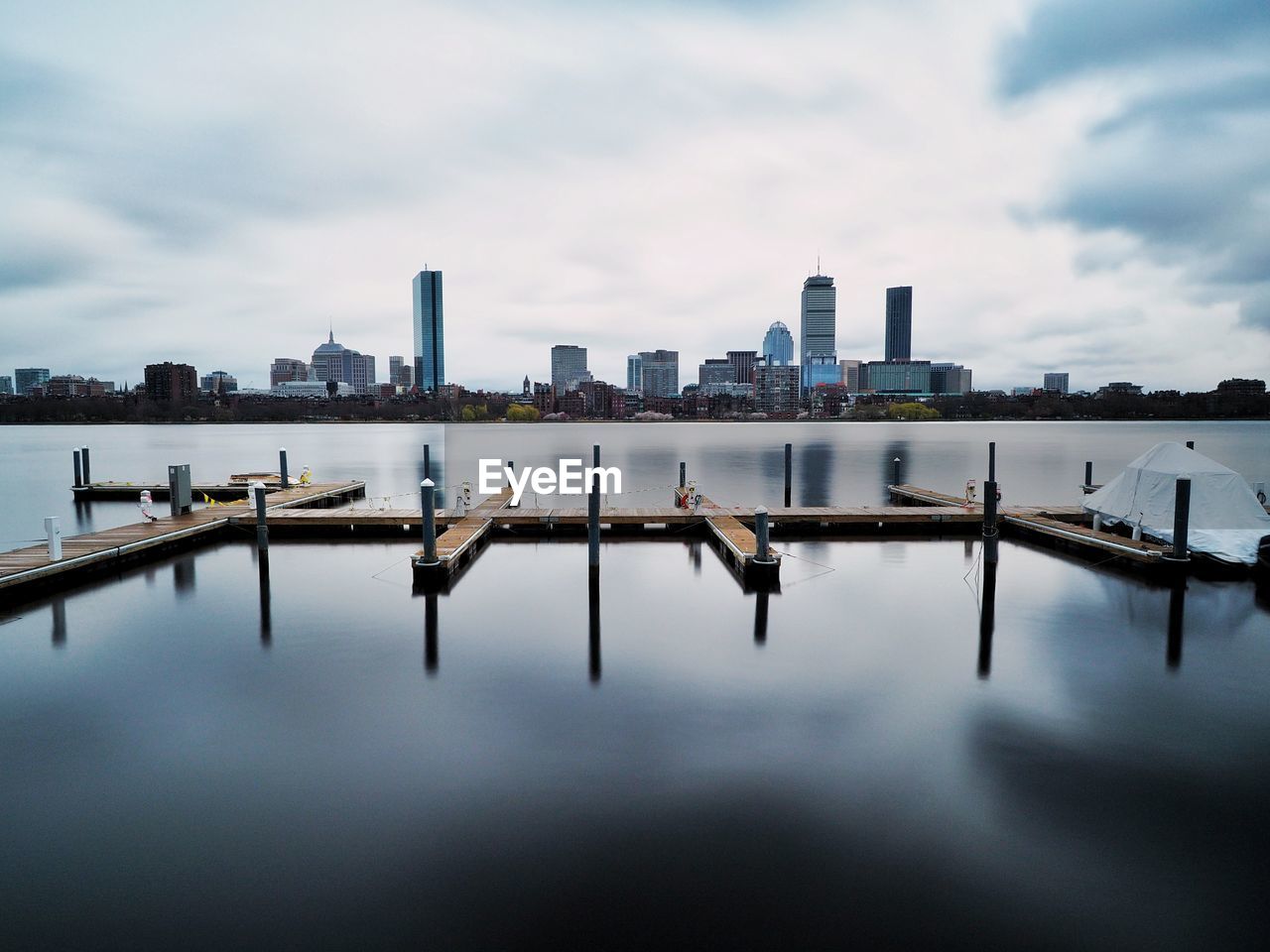 Scenic view of river by buildings against sky