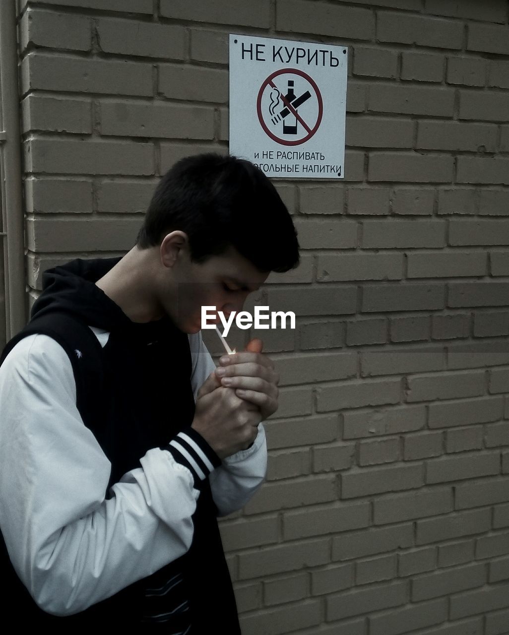 SIDE VIEW OF MAN WITH TEXT AGAINST WALL