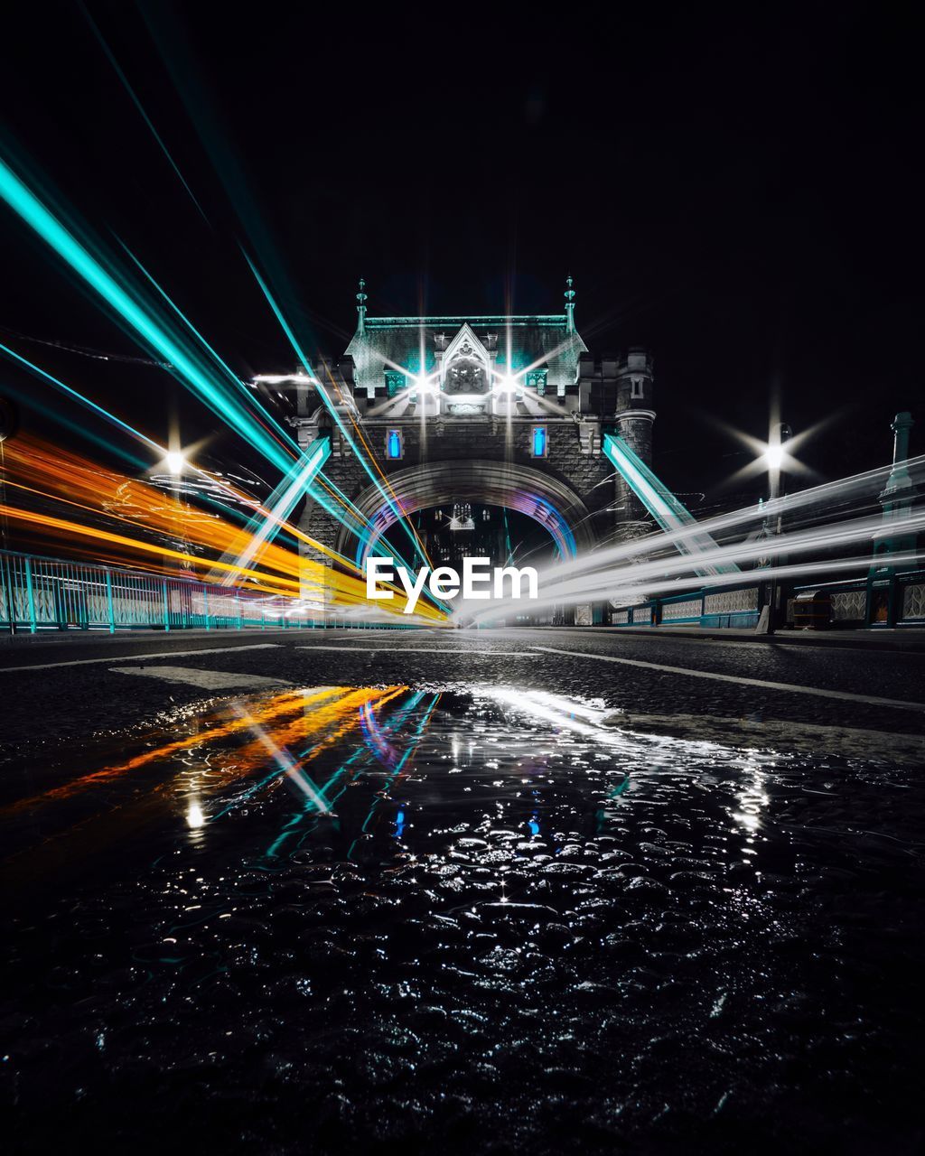 LIGHT TRAILS ON ROAD IN NIGHT