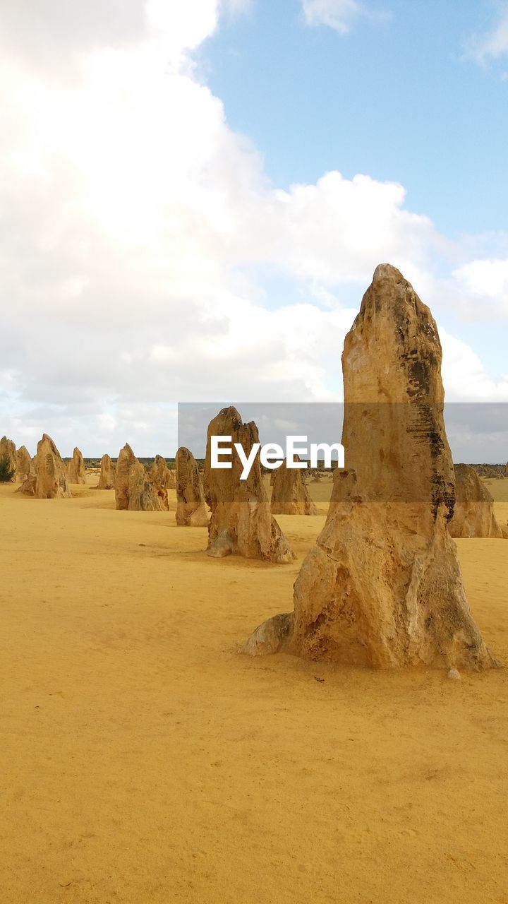 View of rock formations against cloudy sky