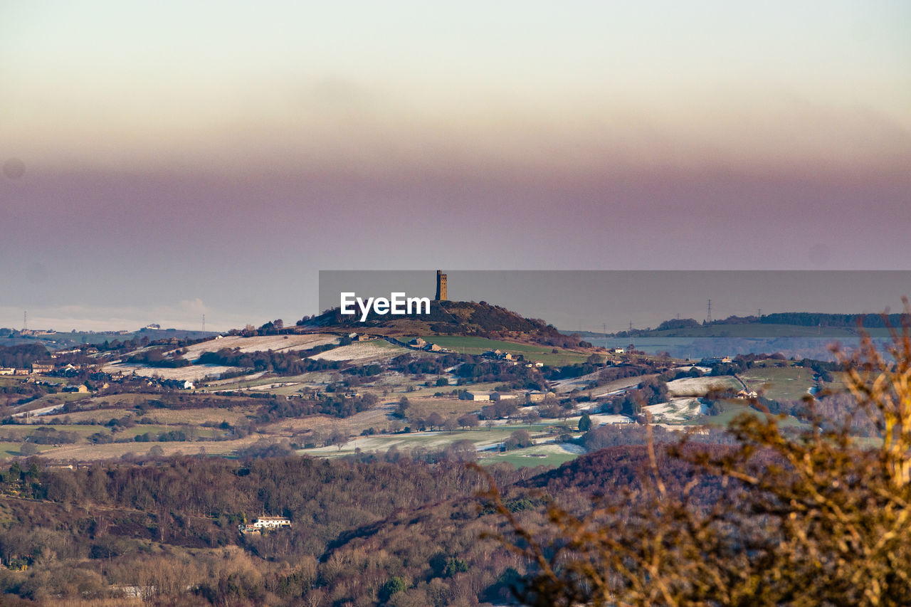 morning, environment, sky, landscape, architecture, horizon, dawn, hill, scenics - nature, nature, building exterior, travel destinations, built structure, building, cloud, land, beauty in nature, travel, snow, winter, tourism, sunrise, no people, cold temperature, city, outdoors, sea, tranquility, tower, tranquil scene, plant, water