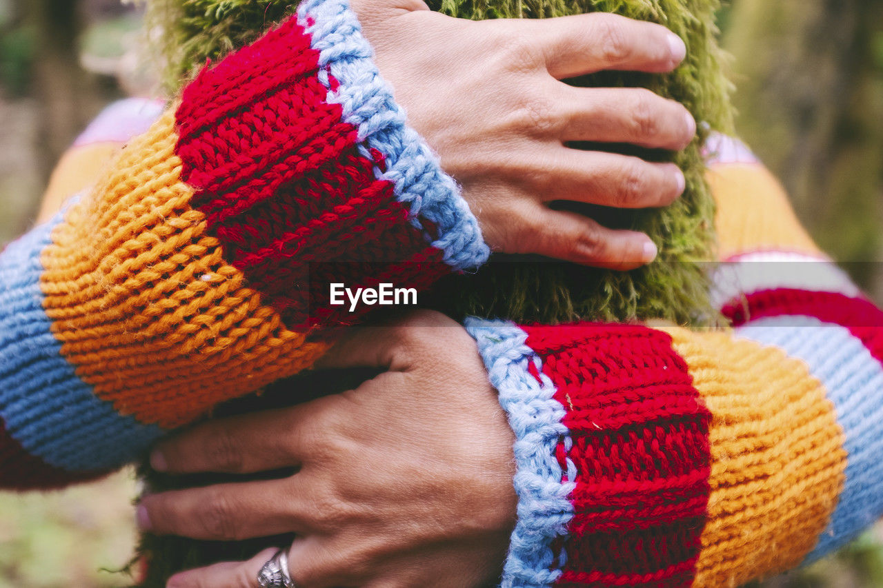 cropped hand of woman wearing knit hat