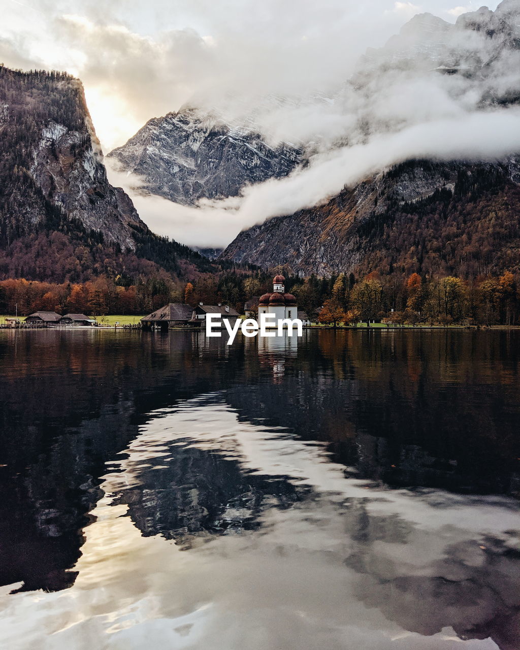 Scenic view of lake and snowcapped mountains against sky