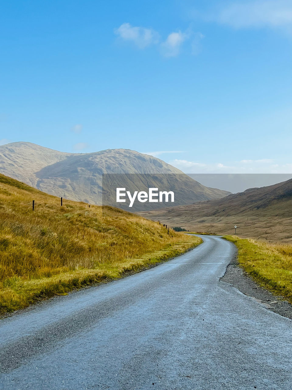 Road amidst mountains against sky