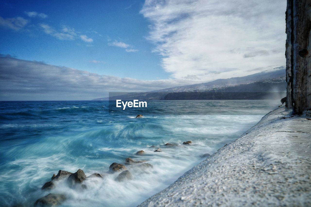 SCENIC VIEW OF SEA BY SNOW AGAINST SKY