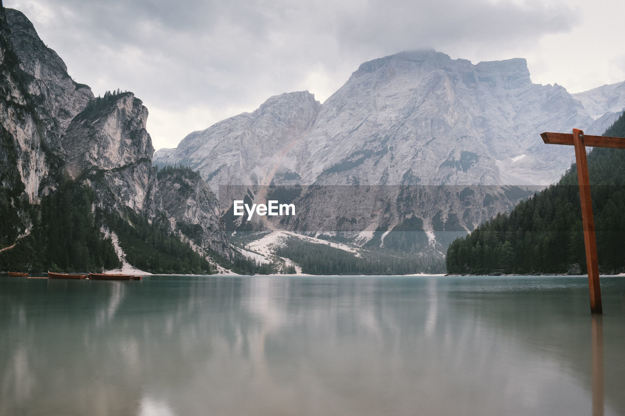 Scenic view of lake by mountains against sky