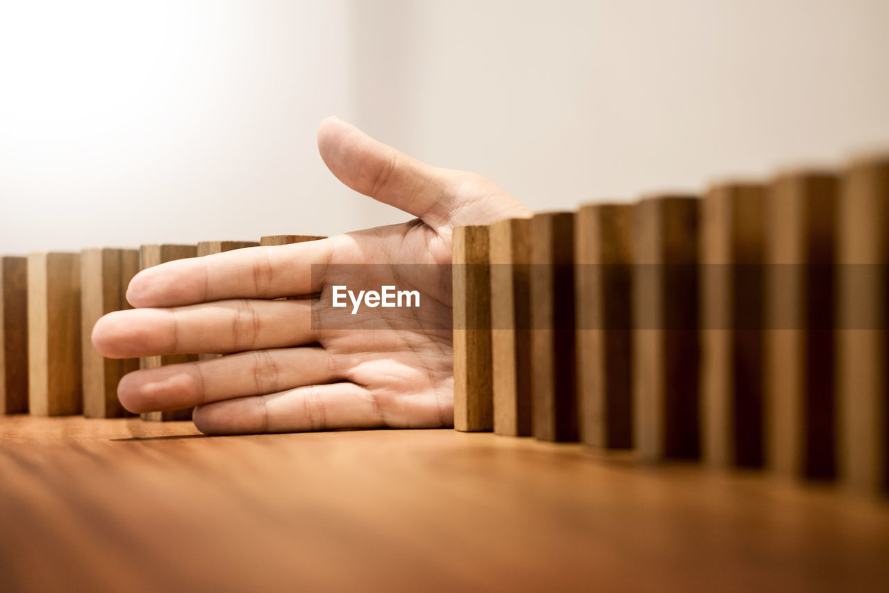 Cropped hand of person on wooden table