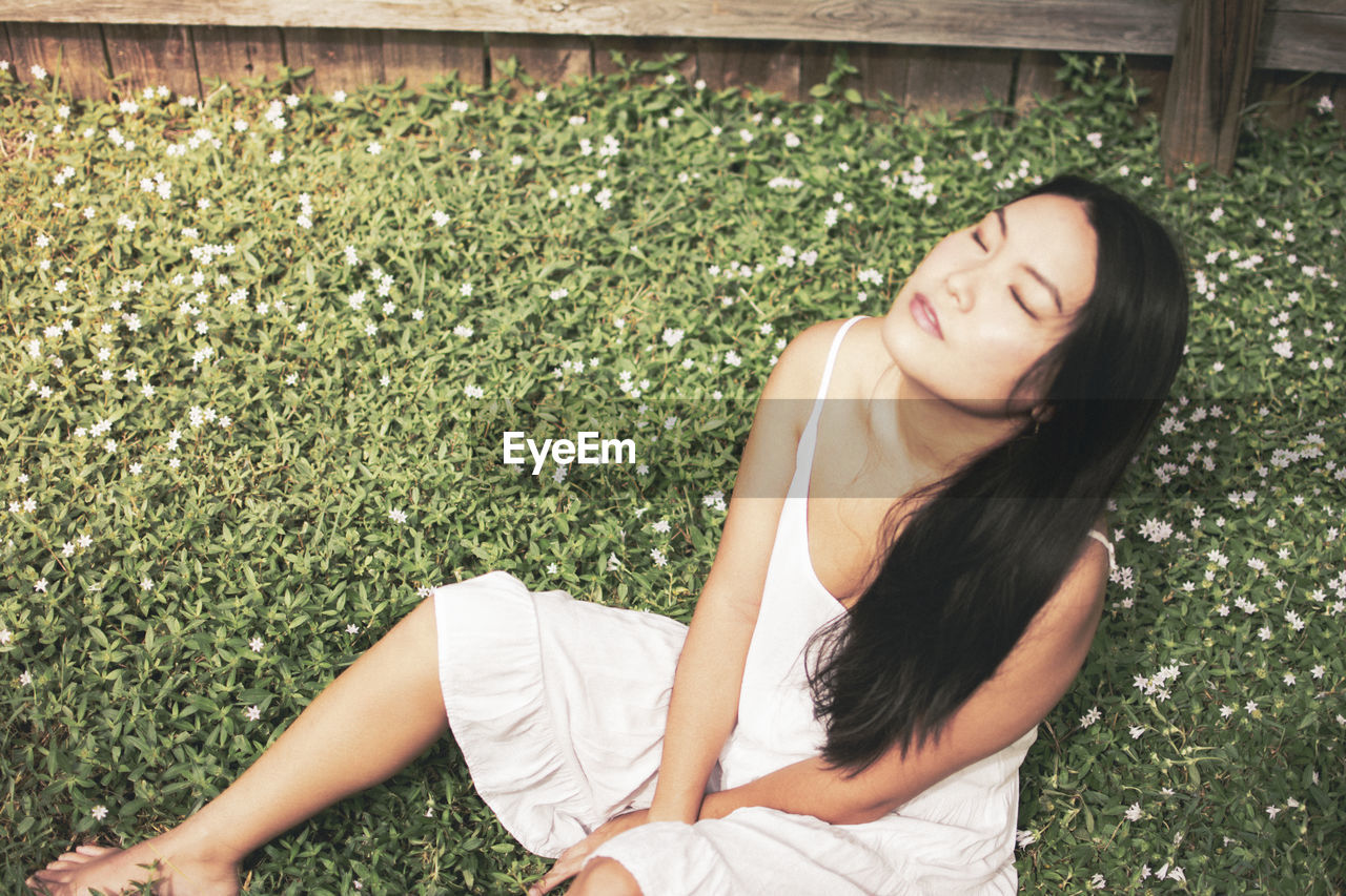 Young woman lying on grass