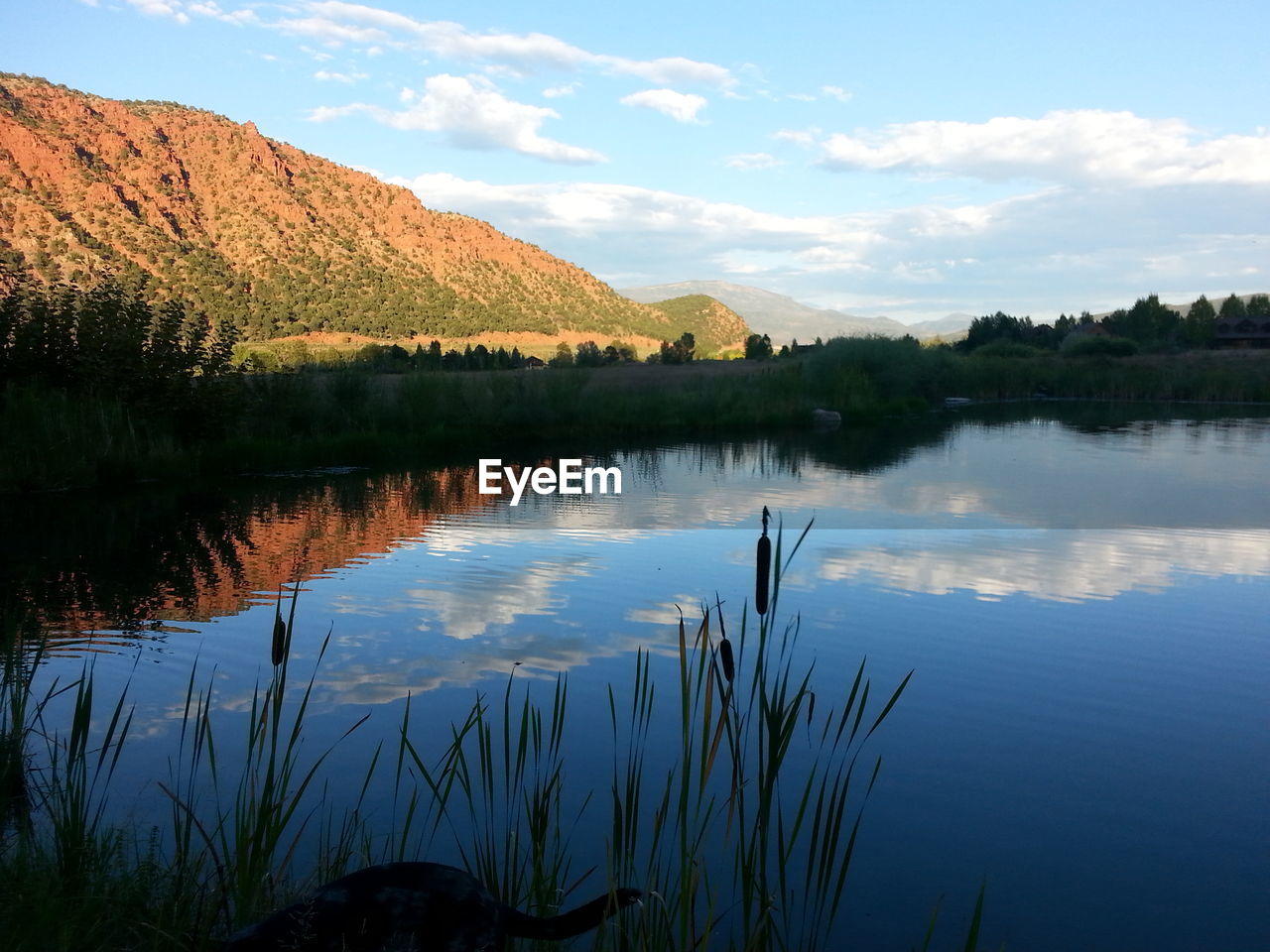 Scenic view of lake and mountain against sky