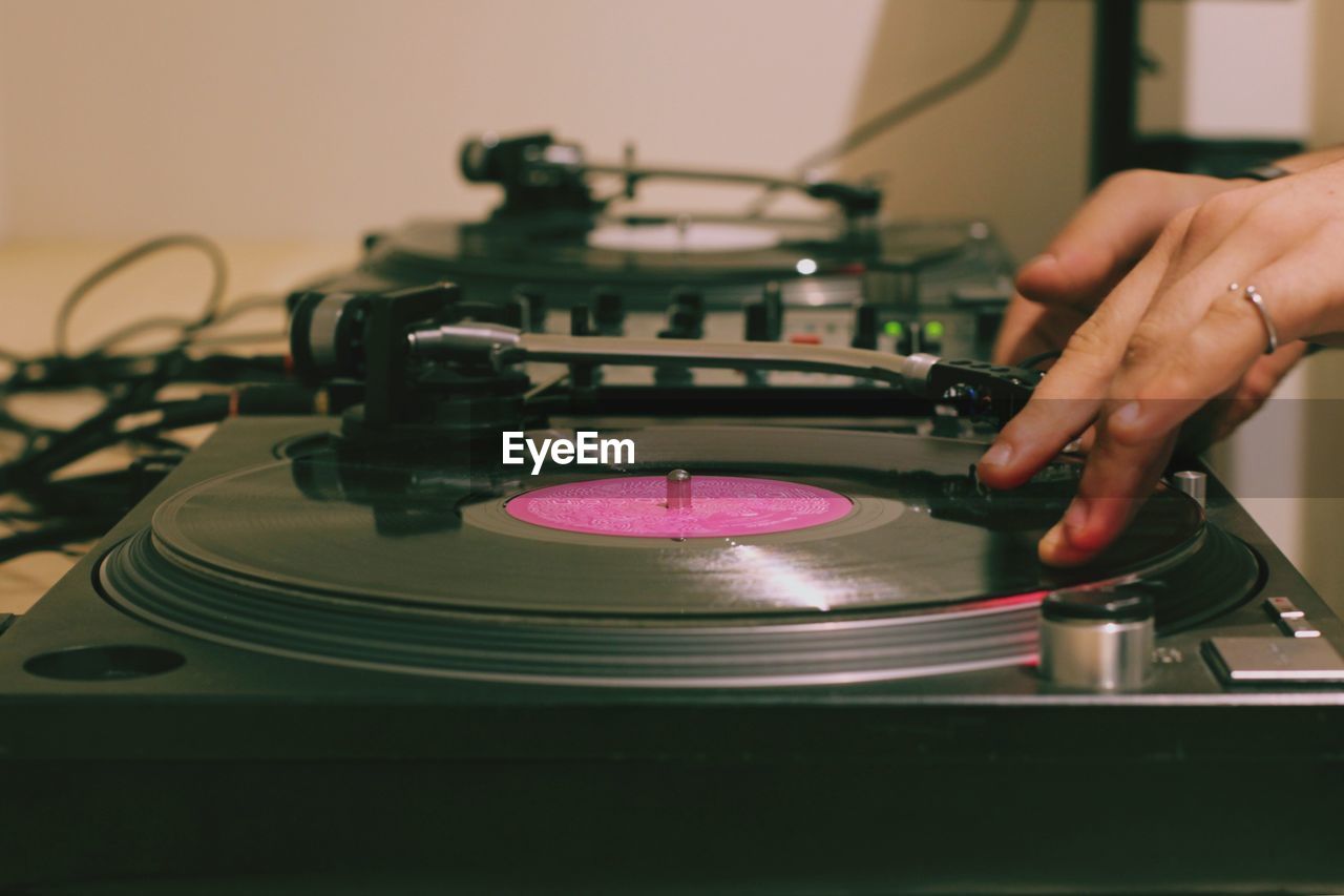 Close-up of man playing turntable