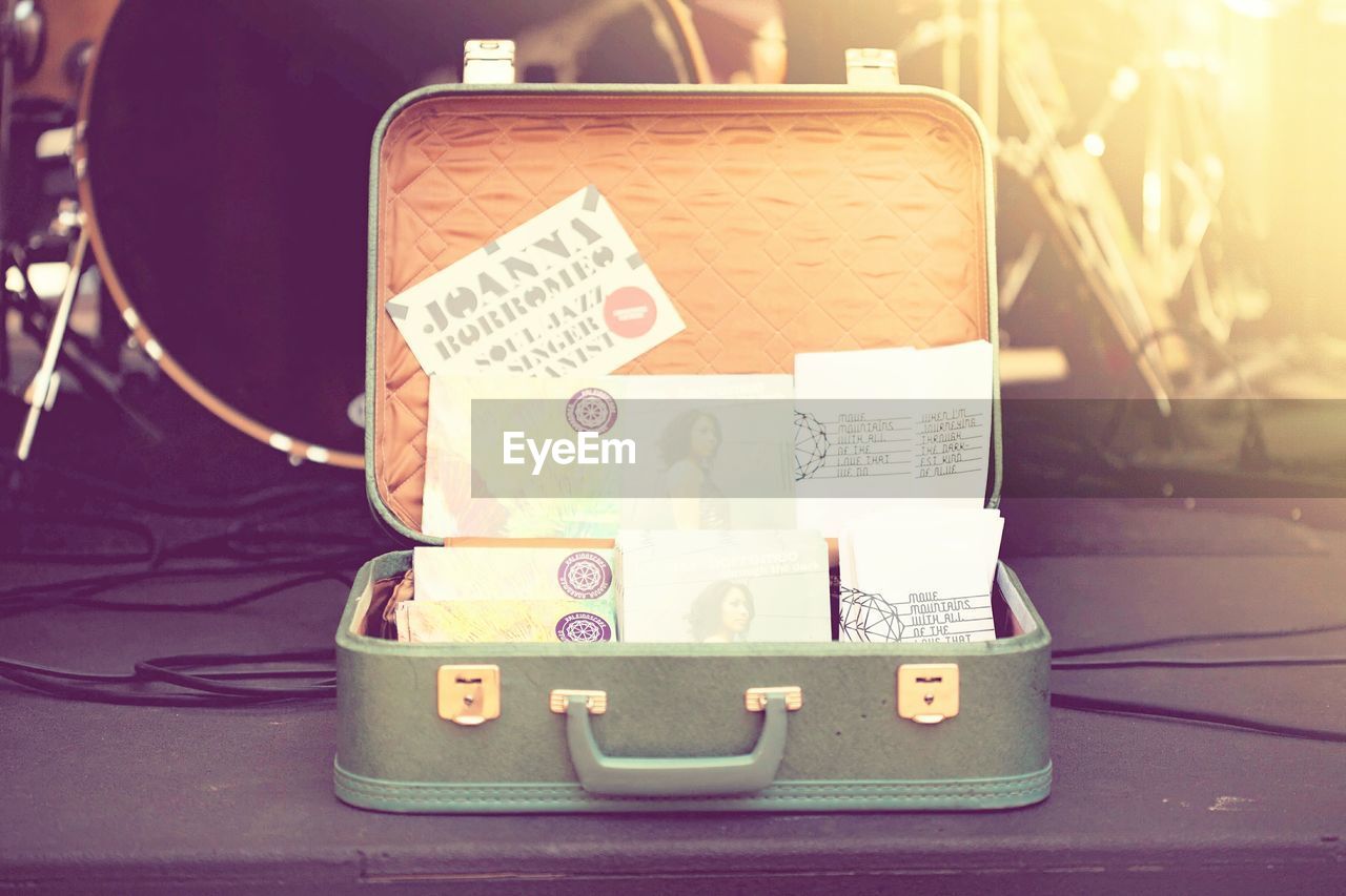 Open briefcase with documents and envelope at backstage
