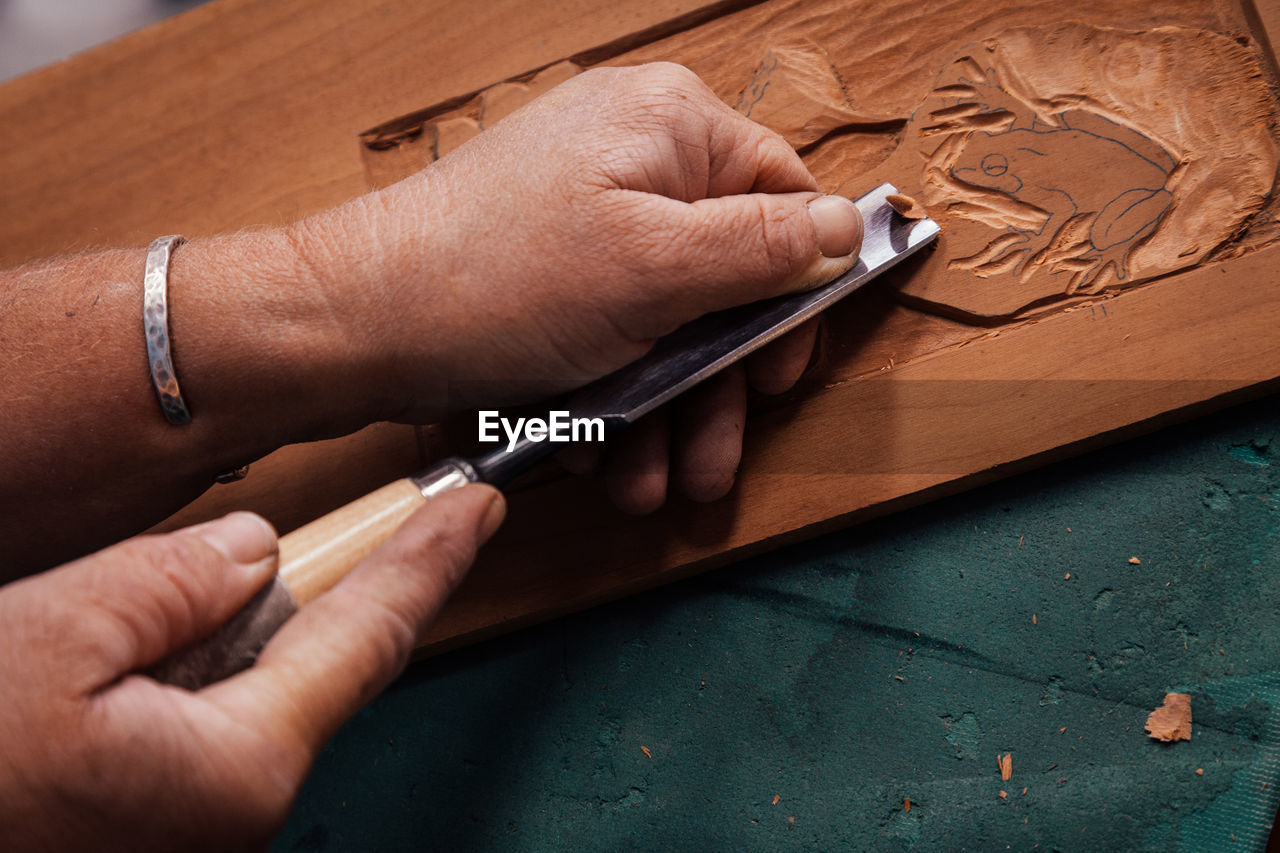 Close-up of carpenter preparing furniture