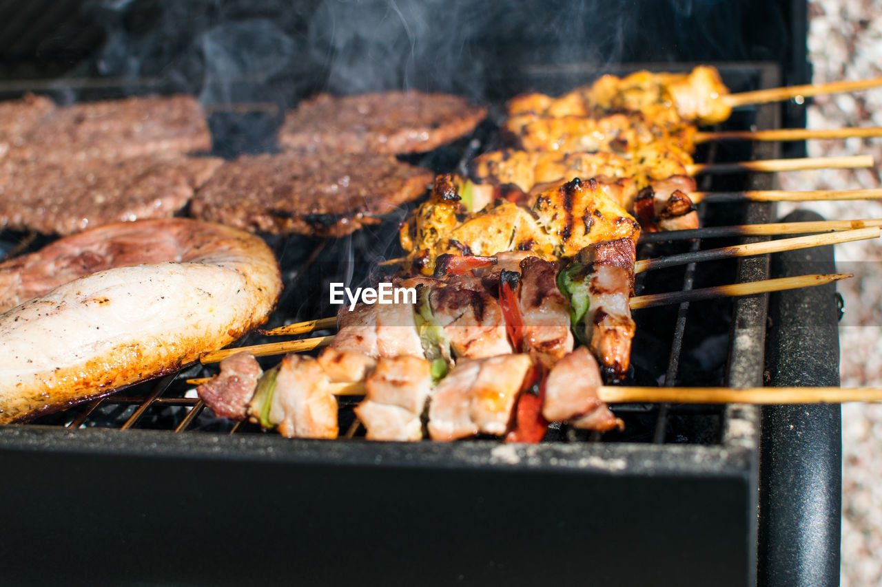 Chickens cooking on barbecue grill