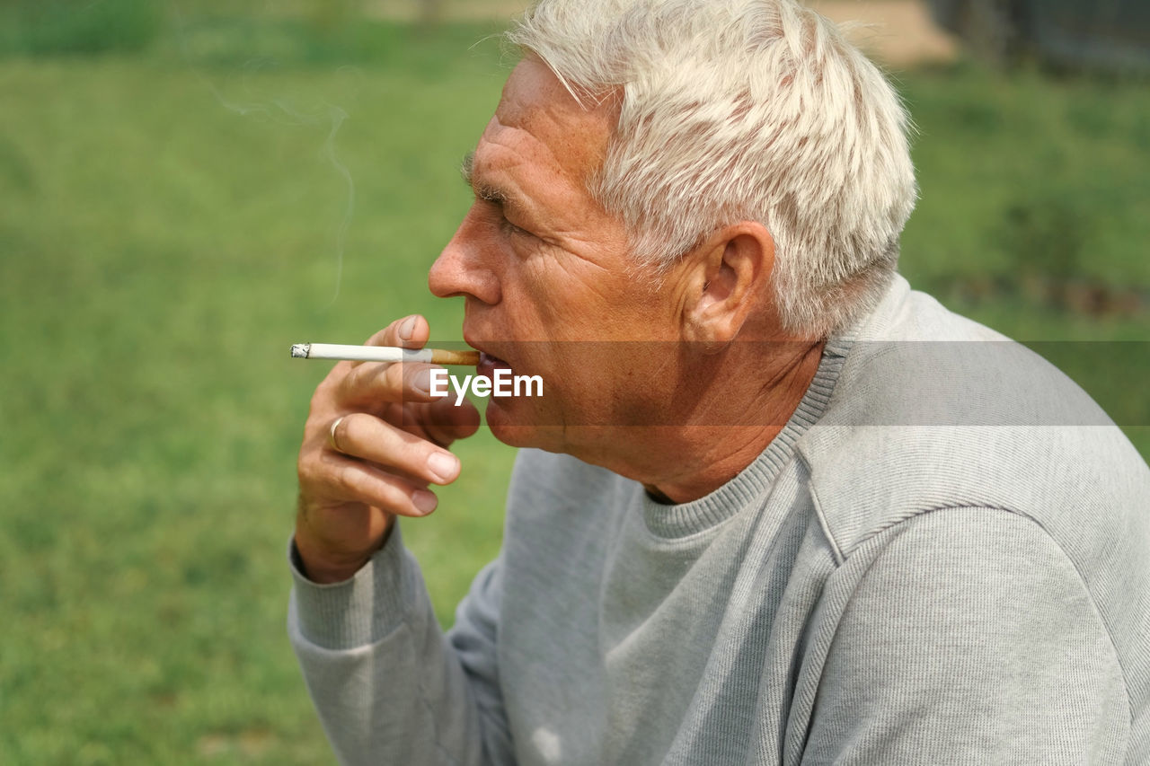 side view of man smoking cigarette