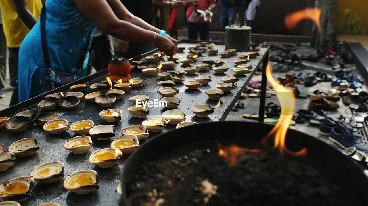 A devotee with oil lamp during thaipusam.