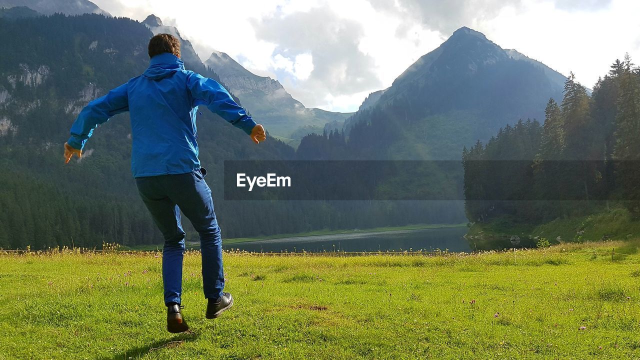 Rear view of man standing on field