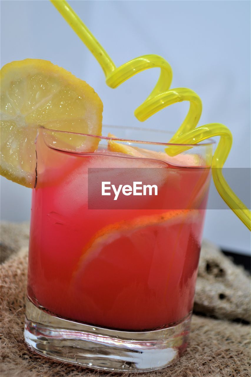 CLOSE-UP OF DRINK WITH GLASS OF JUICE