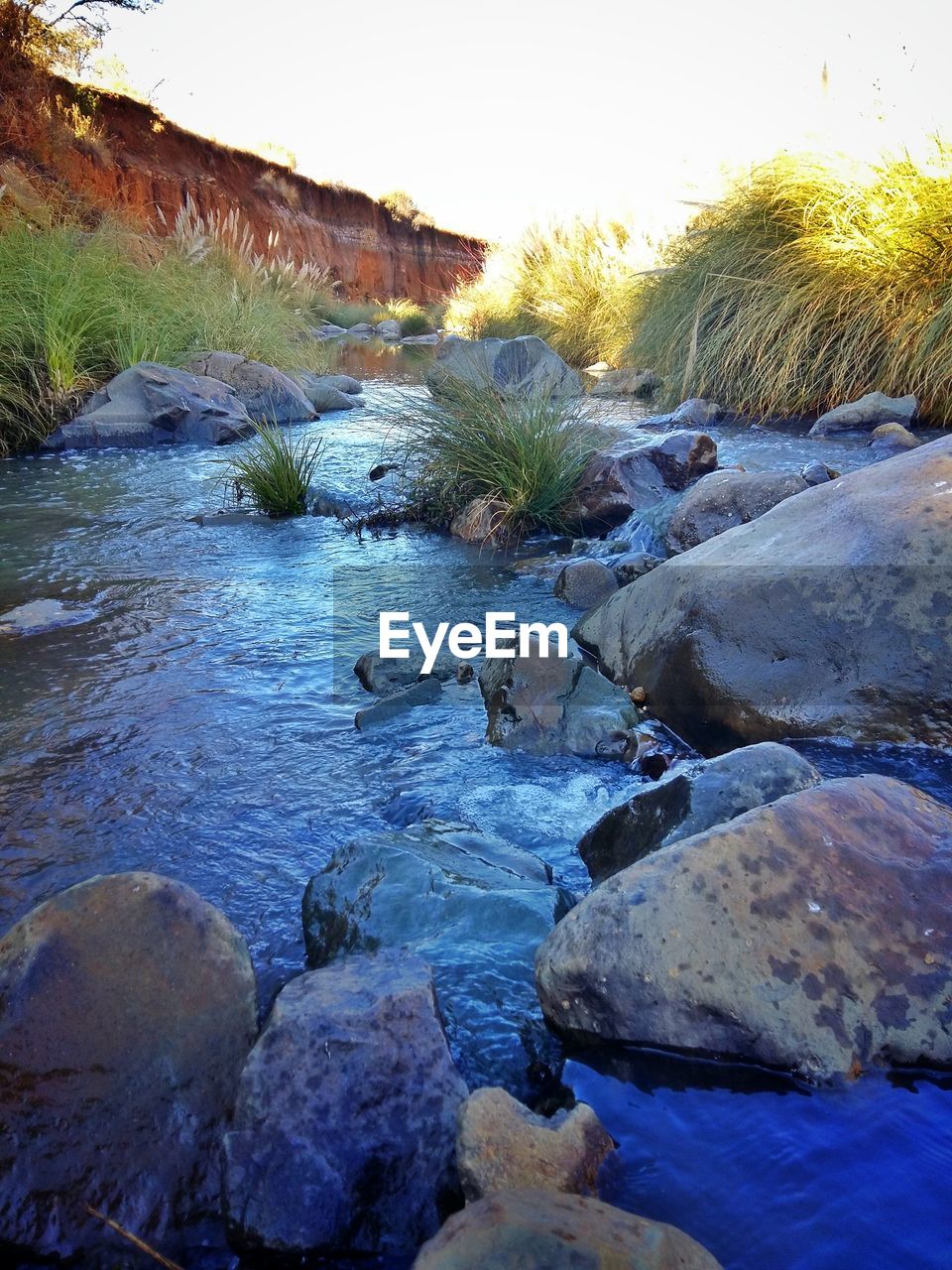 View of stream flowing amidst rocks