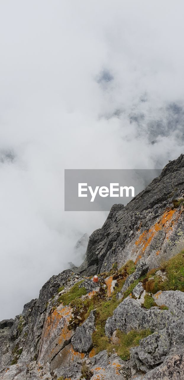 LOW ANGLE VIEW OF ROCK FORMATION AGAINST SKY