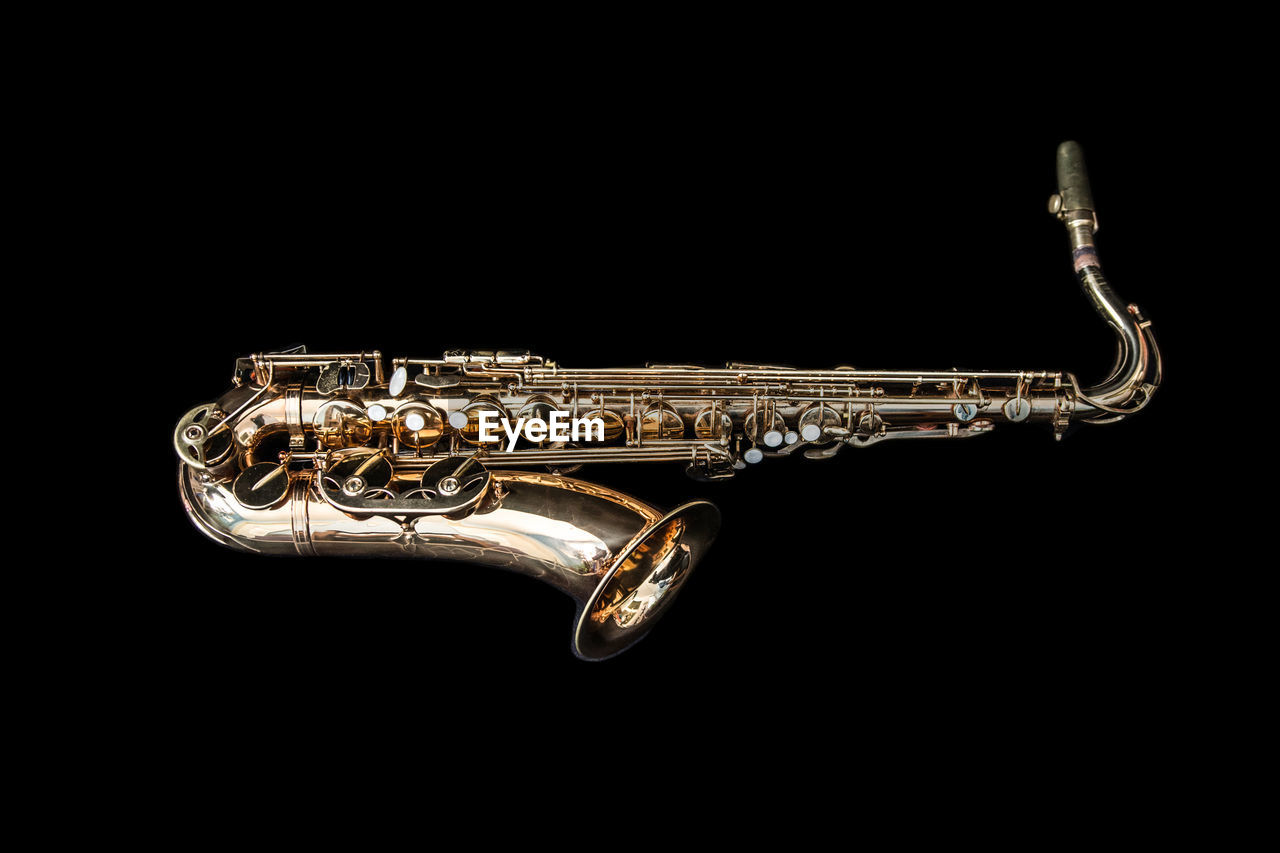 Close-up of saxophone against black background