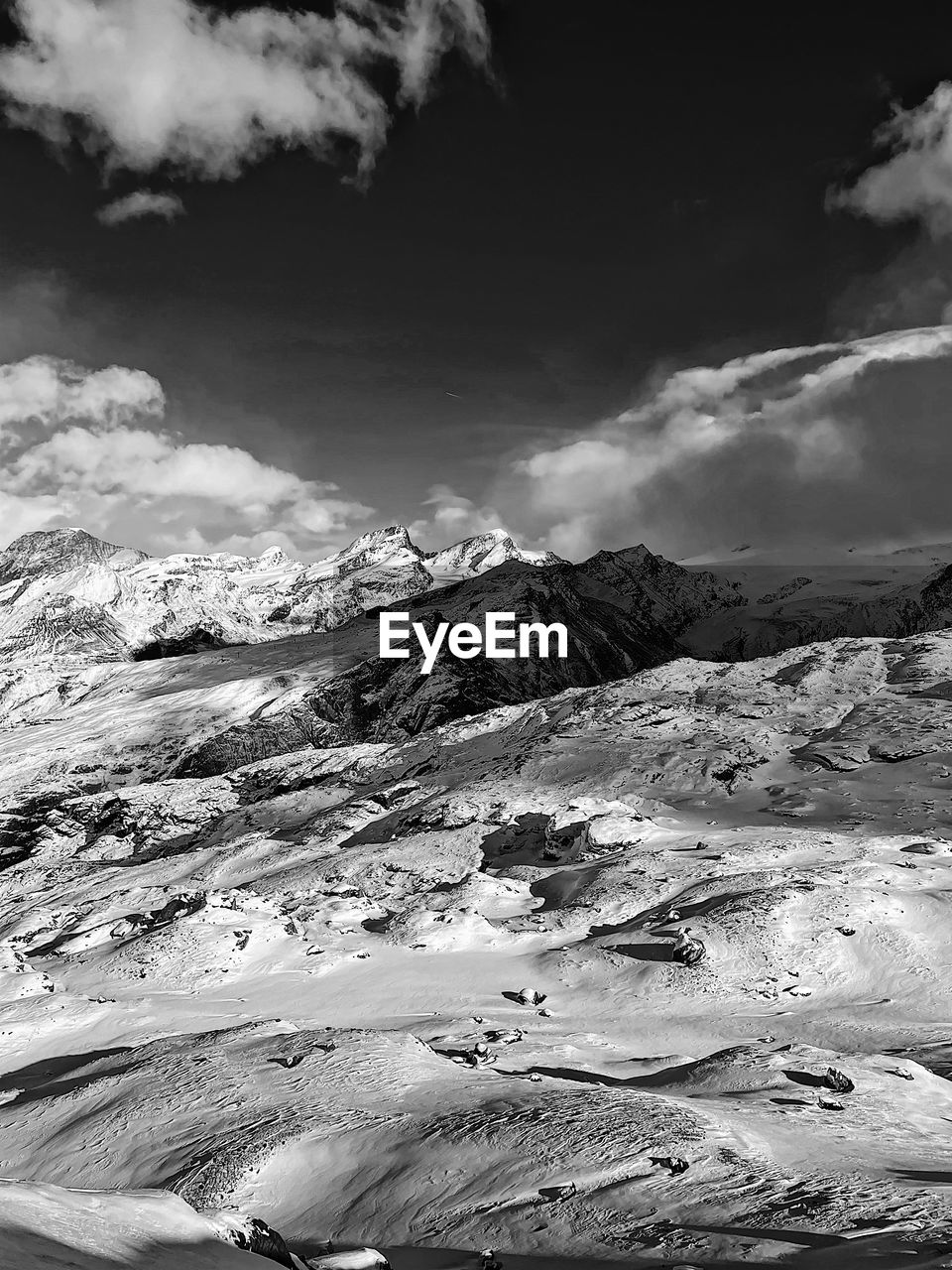 environment, black and white, landscape, scenics - nature, monochrome, snow, monochrome photography, cloud, beauty in nature, sky, mountain, nature, cold temperature, land, winter, tranquility, travel, no people, non-urban scene, mountain range, tranquil scene, travel destinations, outdoors, day, white, extreme terrain, tourism, snowcapped mountain, water, remote, dramatic landscape