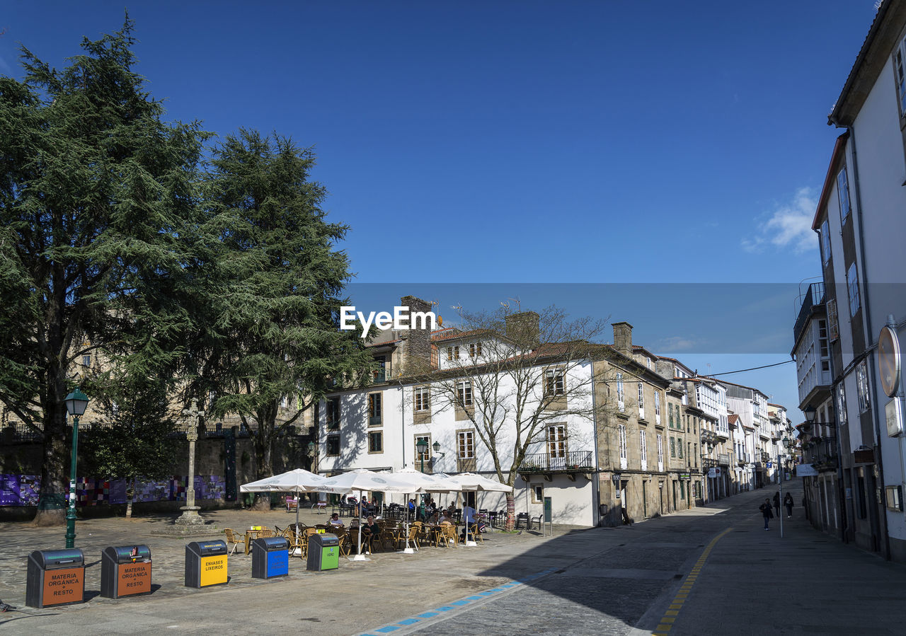 STREET AMIDST BUILDINGS AGAINST SKY