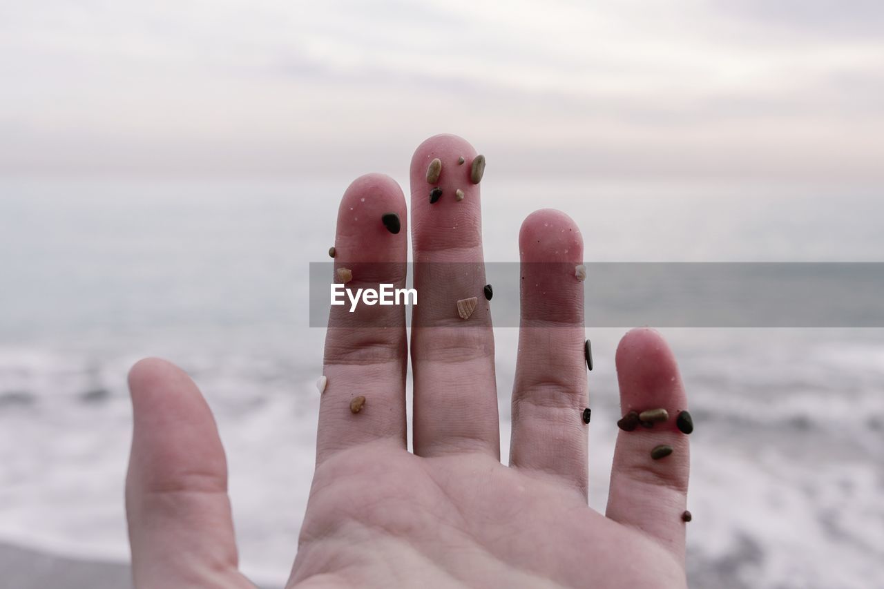 Close-up of hand at beach