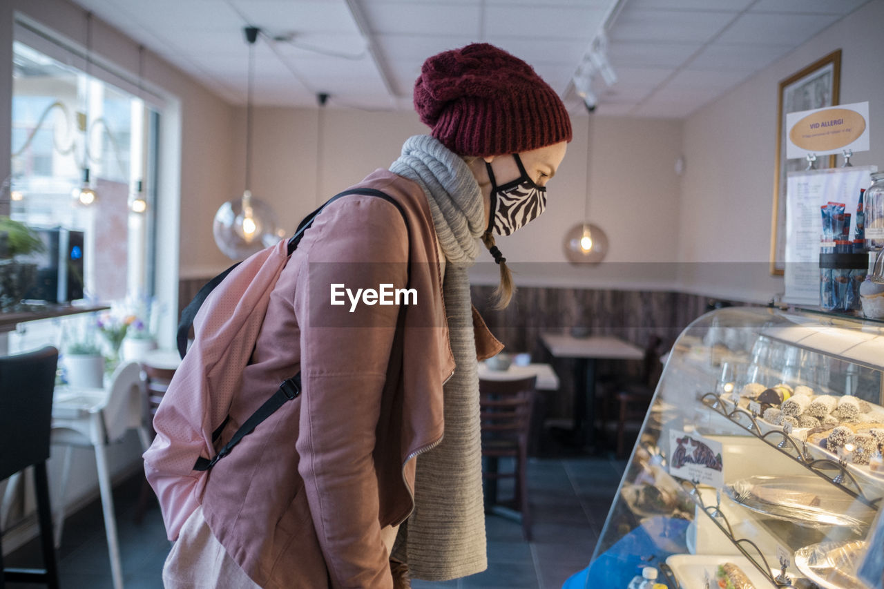 Woman with face mask in café