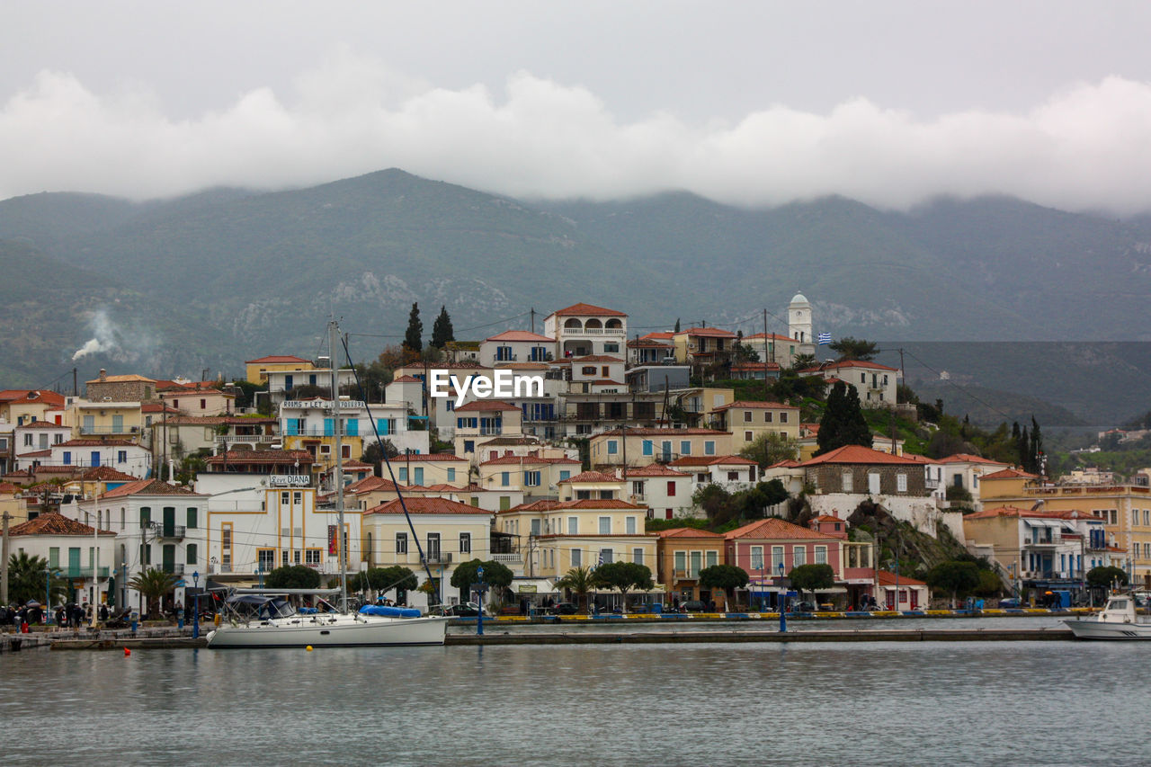 Town by sea against sky in city