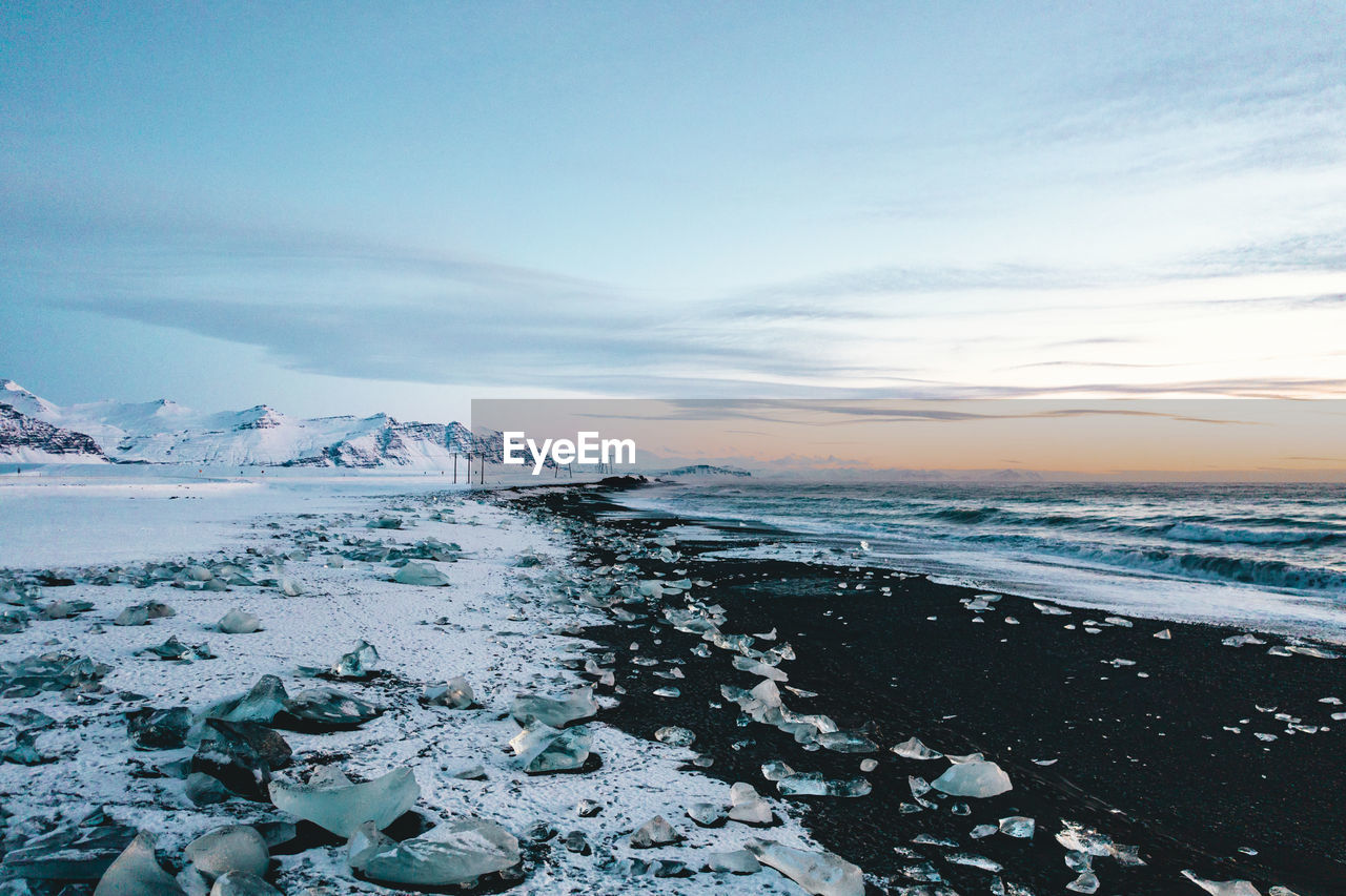Scenic view of sea against sky during winter