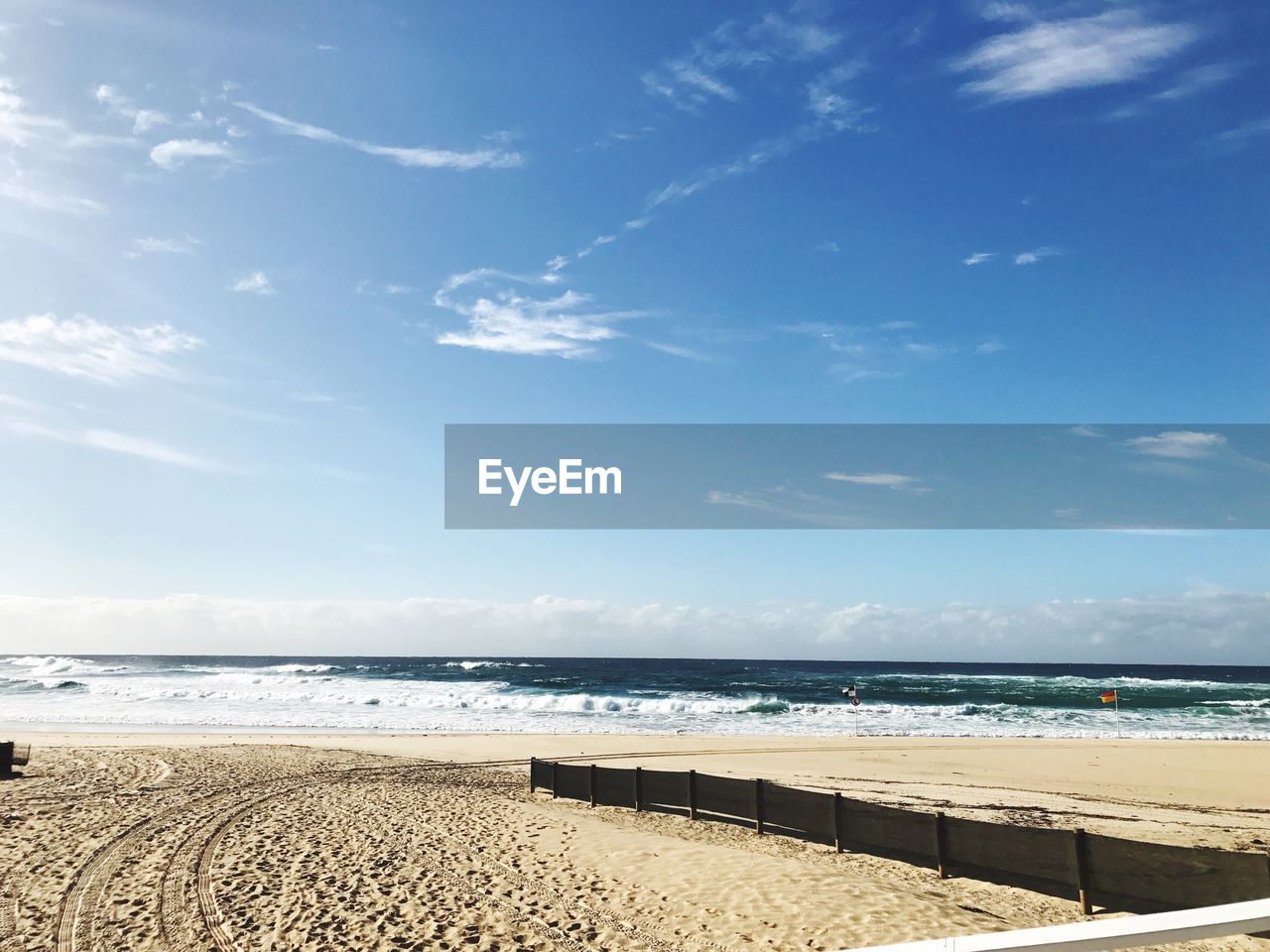 Scenic view of beach against blue sky