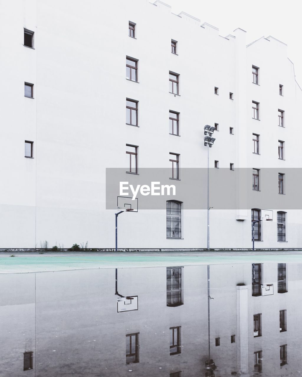 Reflection of building in puddle during rainy season