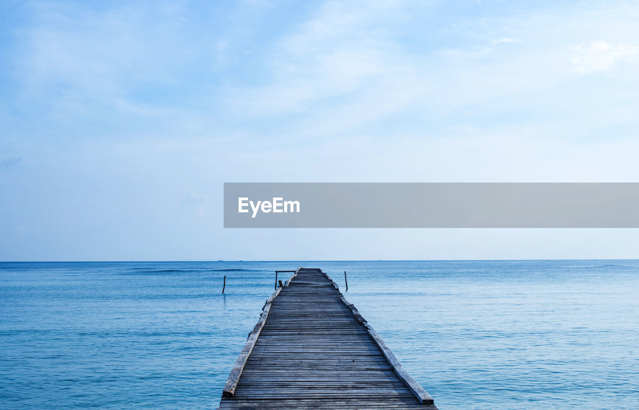 Pier over sea against sky