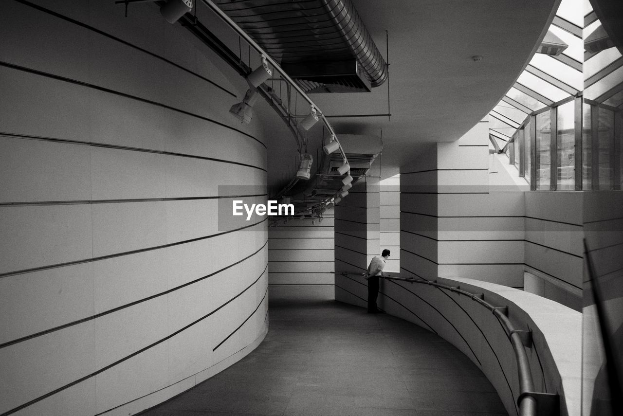 One man on the corridor of a modern building