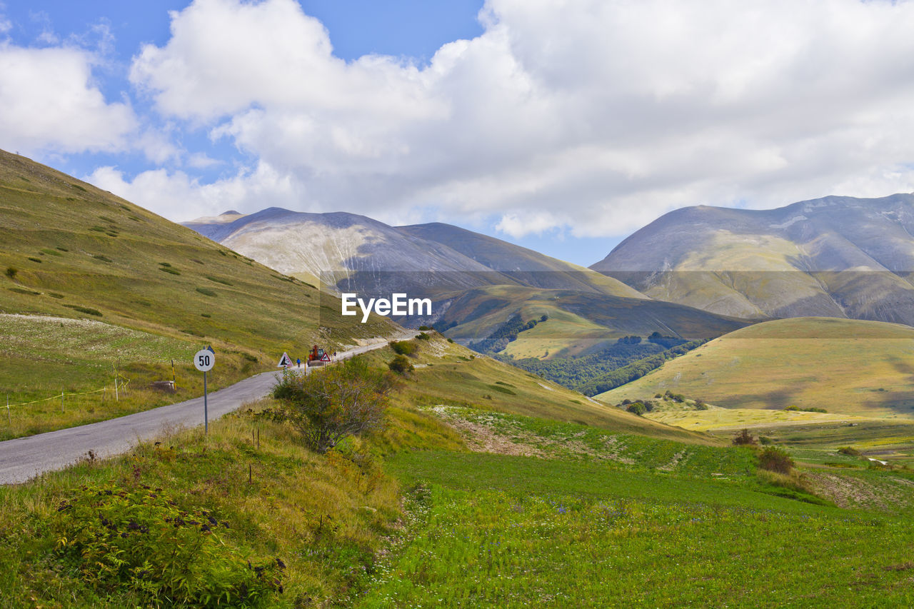 SCENIC VIEW OF ROAD AMIDST LANDSCAPE AGAINST SKY