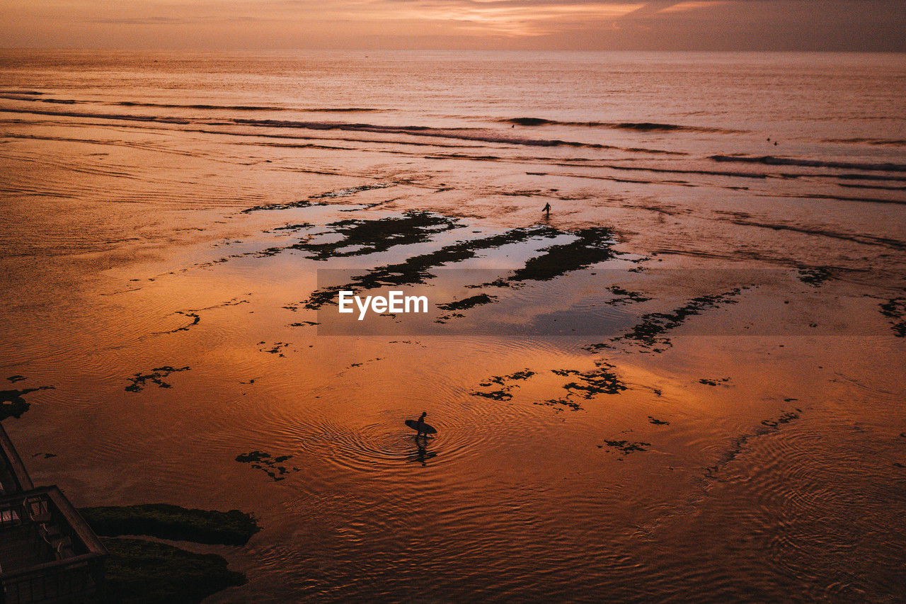 high angle view of beach against sky during sunset