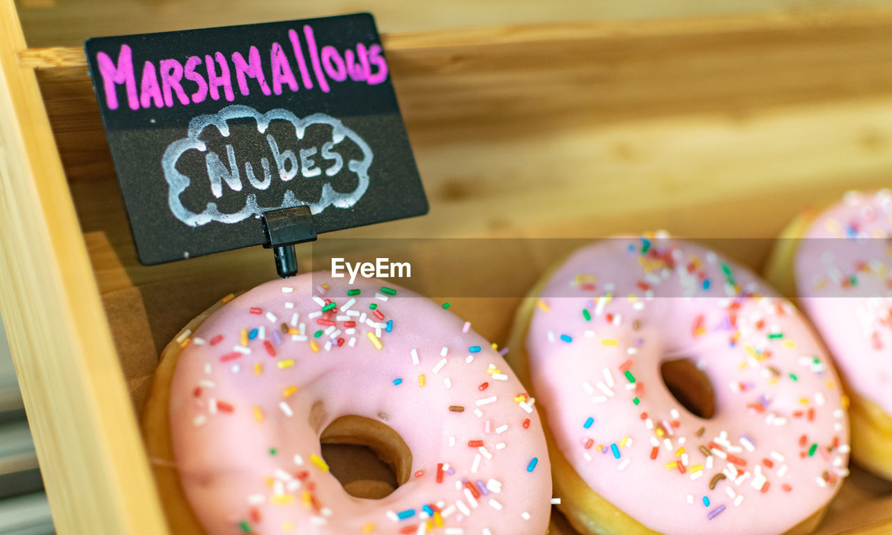 Close-up of multi colored marshmallow flavour doughnuts 