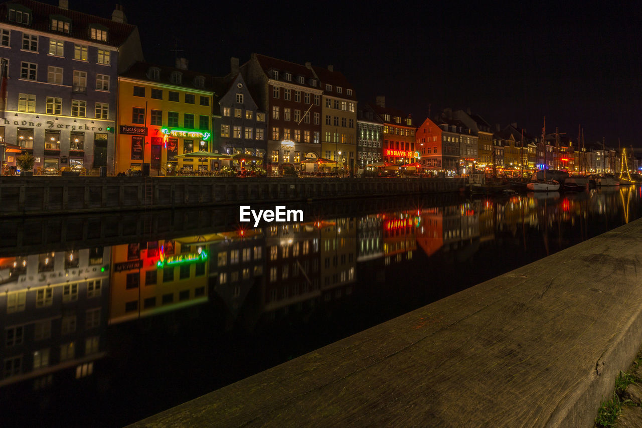 REFLECTION OF ILLUMINATED BUILDINGS IN RIVER