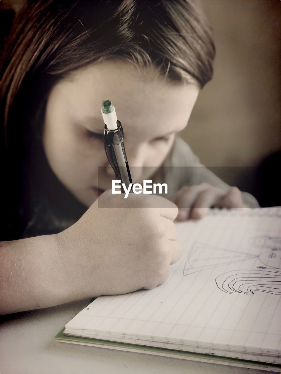 Cute girl writing in book