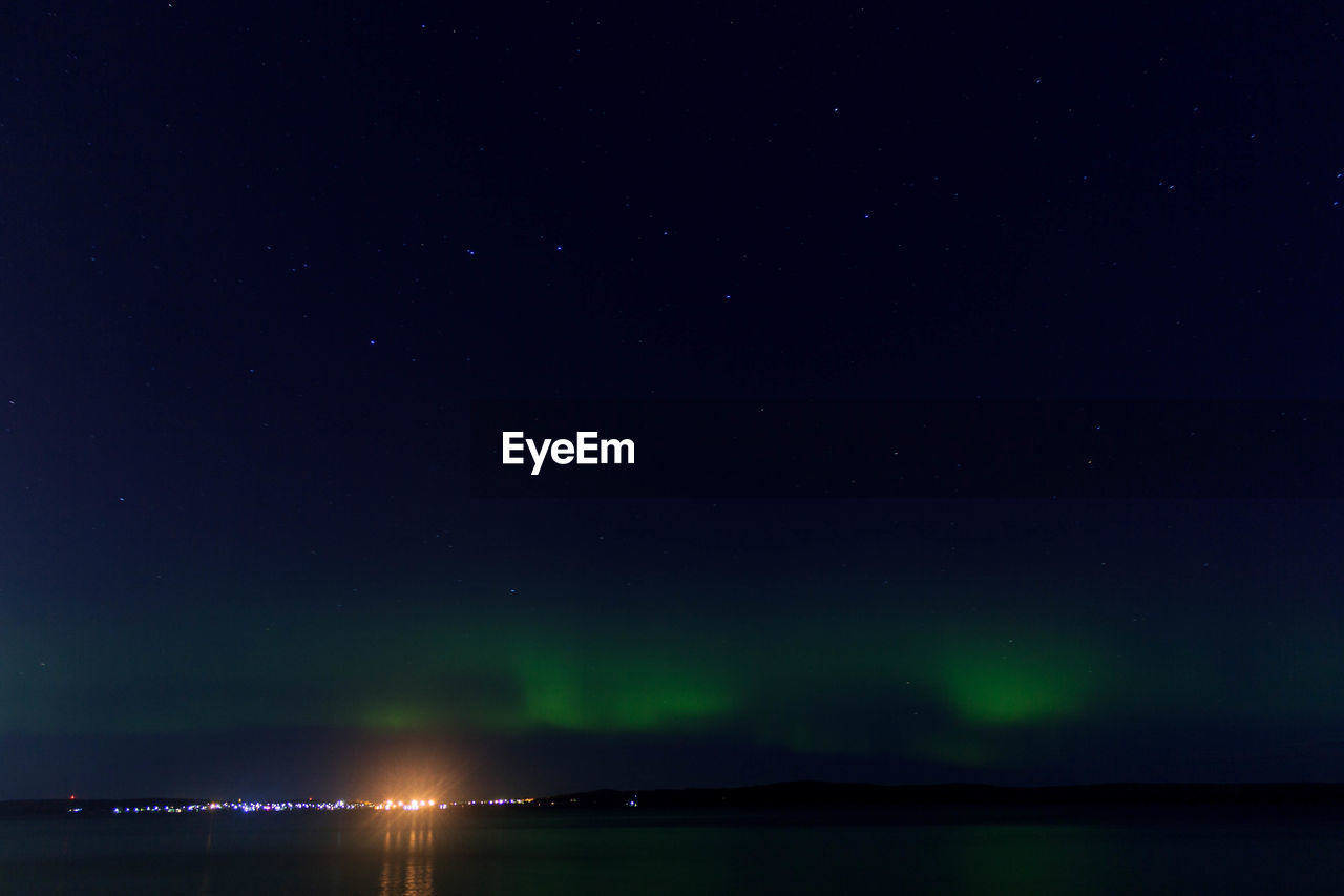 Scenic view of lake against sky at night