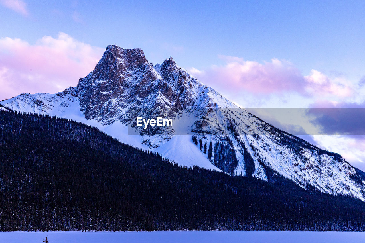 Snow covered mountain during sunset in the snowy canadian rockies.