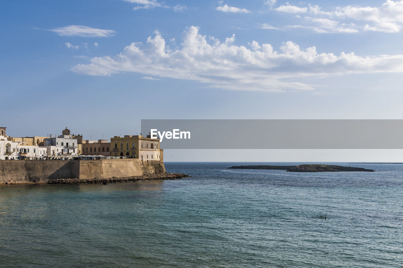 SCENIC VIEW OF SEA AGAINST BUILDINGS