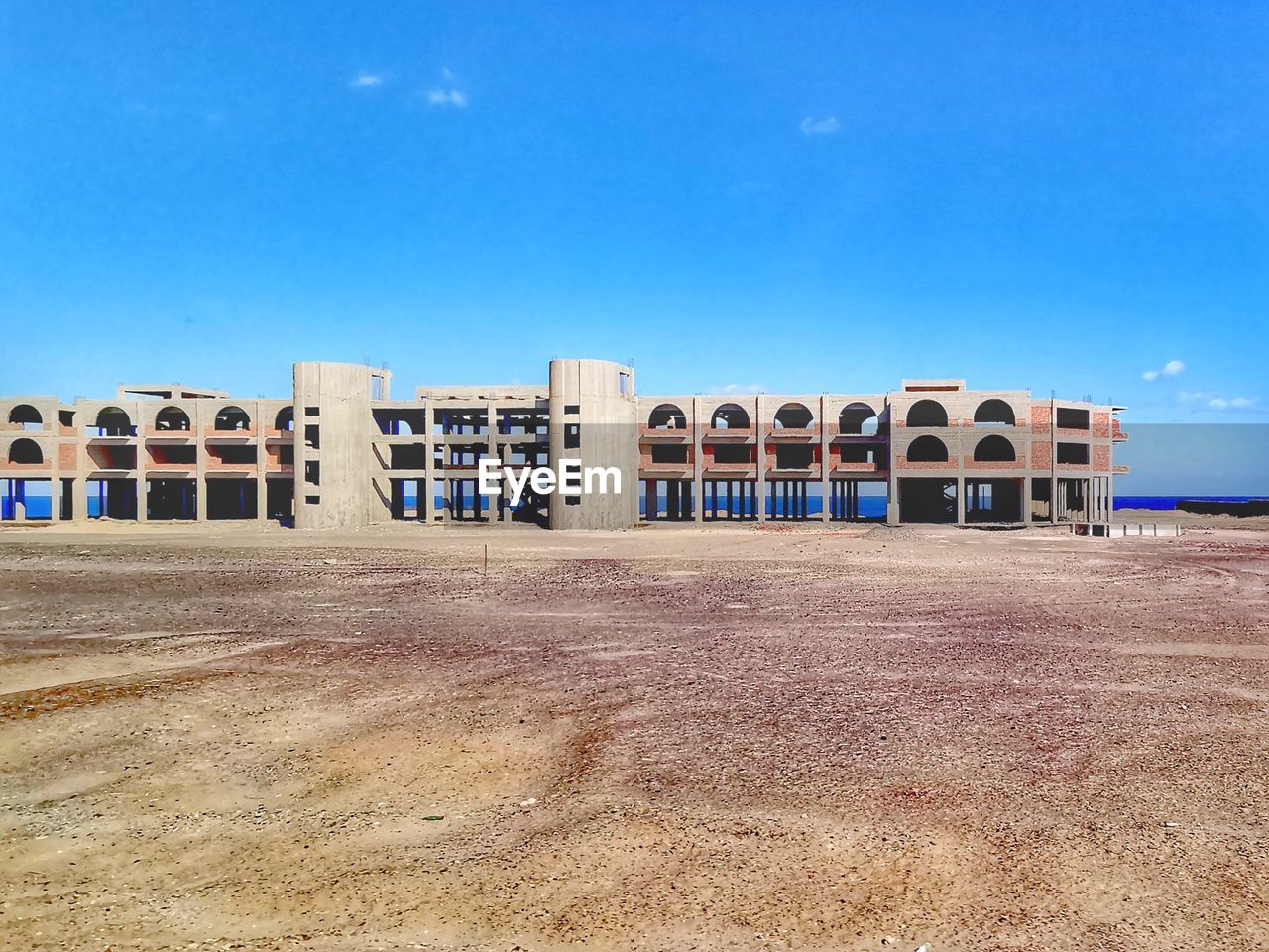 BUILT STRUCTURE ON BEACH AGAINST SKY