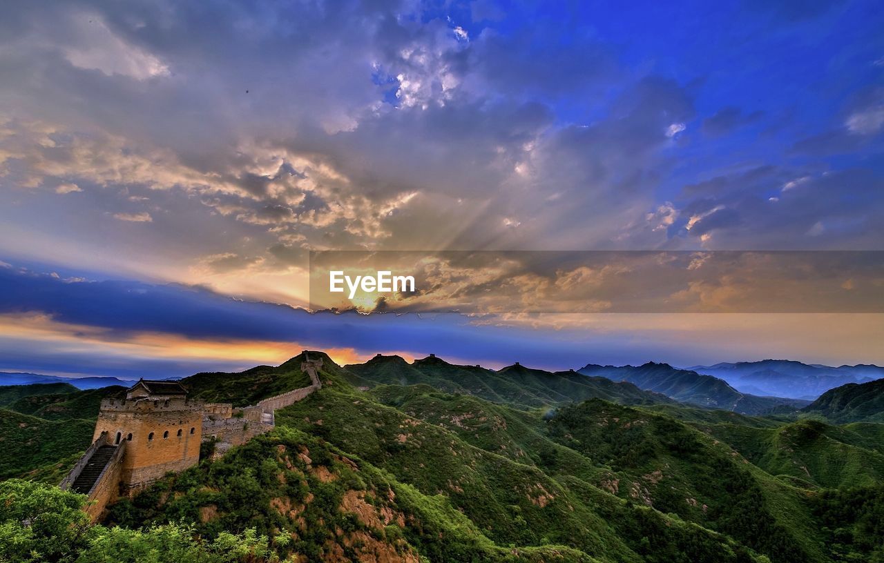 PANORAMIC SHOT OF BUILDINGS AGAINST SKY DURING SUNSET