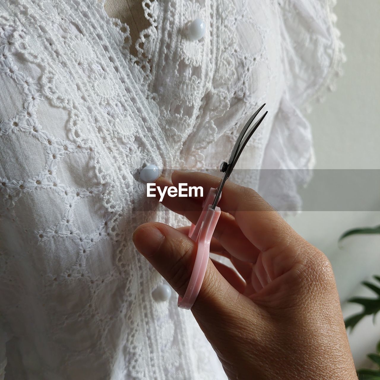 Woman hand checking second hand dress for display to sale