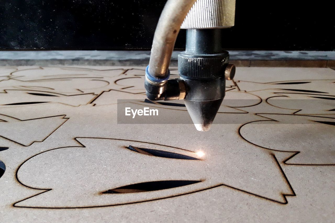 Close-up of cnc machine over sheet metal 