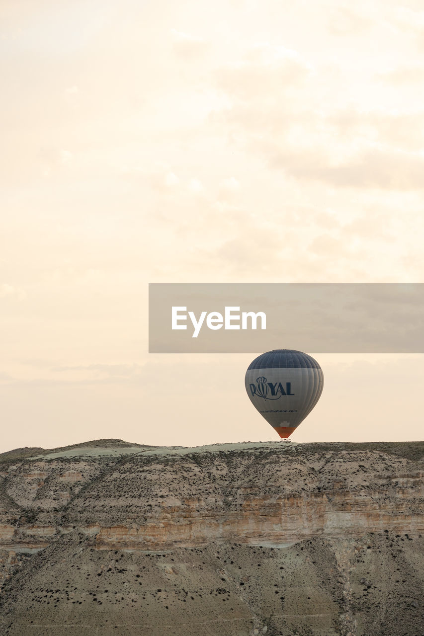 VIEW OF HOT AIR BALLOON FLYING OVER LAND