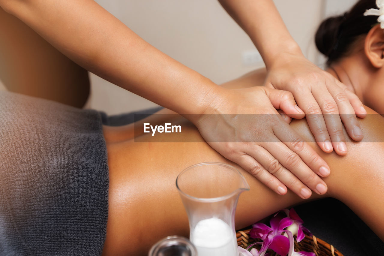 midsection of woman washing hands in glass